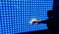 A person infront of an LED screen display