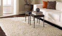 Modern living room featuring a bold contemporary rug with geometric patterns in neutral tones.